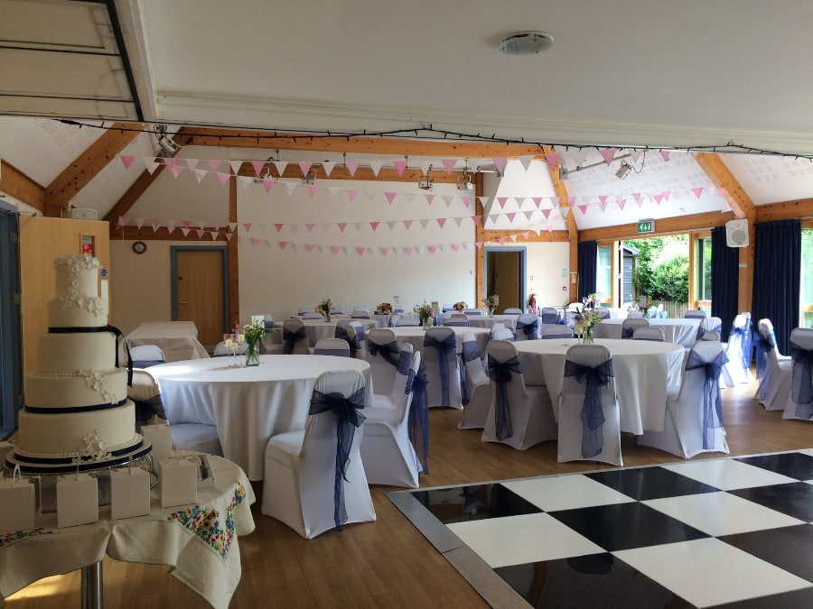 Wedding Table with Cake aside Dance Floor at Petham Village Hall