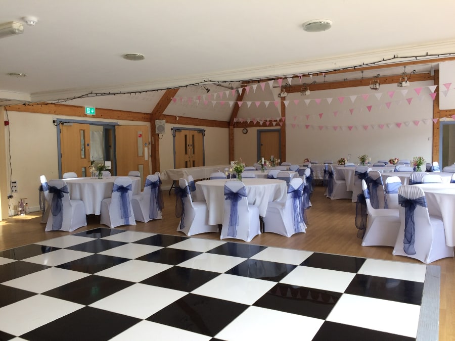wedding tables and chairs aside dance floor at Petham Village Hall